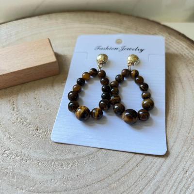 Boucles d oreilles marron et dorees